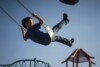 young boy on swing in playground